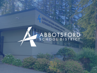 Picture of the School Board Office building with Abbotsford logo overtop