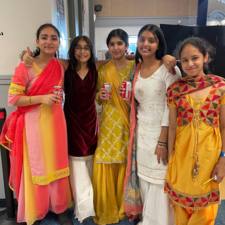 Five middle school girls pose for photo dressed in traditional attire to celebrate Diwali