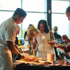 Attendees getting food from a venue worker